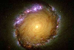 Anillo nuclear de la galaxia NGC1512. Las zonas violetas son regiones de formación de estrellas. | NASA | ESA